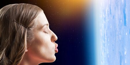 Girl kissing Earth planet . Mixed mediaの写真素材