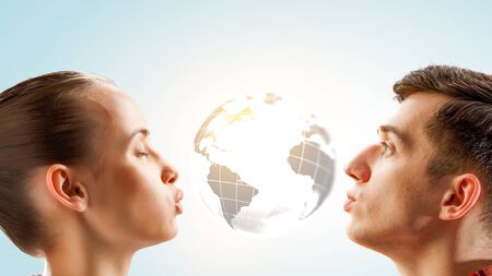 Guy and girl kissing planet. Mixed mediaの写真素材