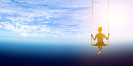 Fantasy image with kid riding swing in space