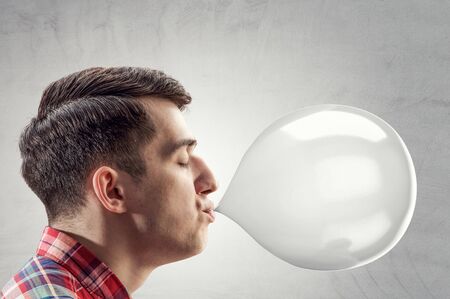 Guy blowing bubble . Mixed mediaの写真素材