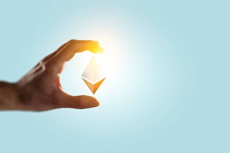 Male hand on blue background take ethereum symbol. 3d rendering