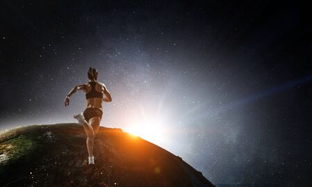 Young athlete girl running on globe.の写真素材