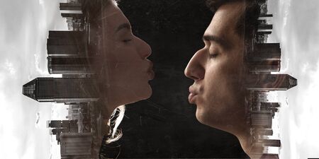 Couple of lovers kissing against night city background