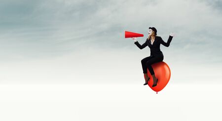 Mime woman in black suit and red balloons. Mixed mediaの写真素材