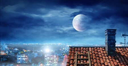 Brick house roof against blue sky. Mixed mediaの写真素材