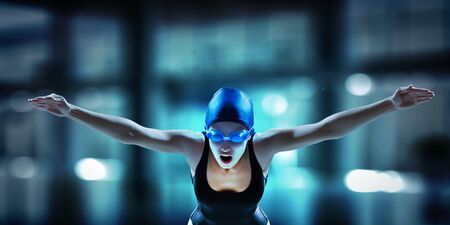 Swimmer woman ready to jump into swimming pool. Mixed mediaの写真素材
