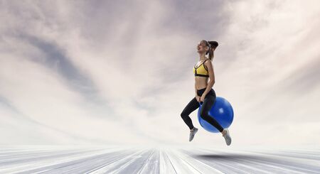 Sporty woman on fitness ball. Mixed media