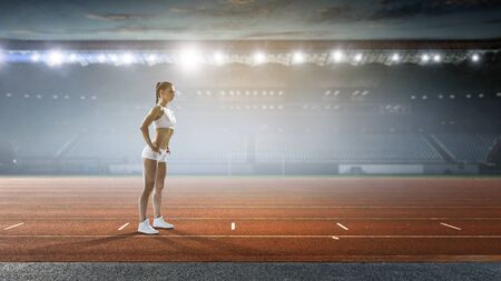 Female athlete warming up on the running track. Mixed mediaの写真素材