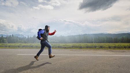 Male tourist with backpack walking outdoor. Mixed media