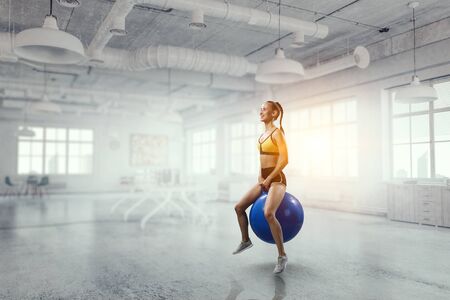 Sporty woman on fitness ball. Mixed mediaの写真素材
