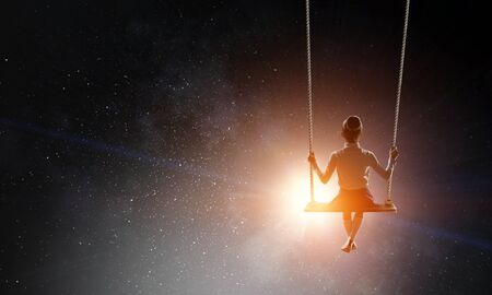 Cute little girl riding on swing. Mixed mediaの写真素材