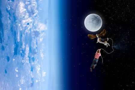 Fantasy image of boy fly in open space