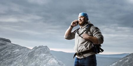 Hiker man in mountains. Mixed media