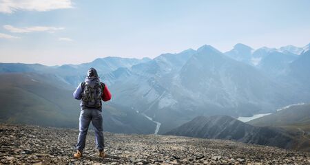 Hiker man in mountains. Mixed media