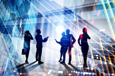 Silhouettes of business people on modern building background