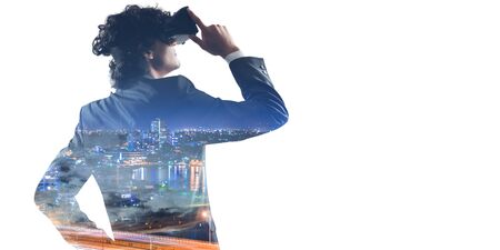Young businessman using virtual reality headset. Mixed media