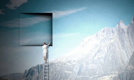 Businesswoman standing on ladder and climbing up to window. Mixed mediaの写真素材