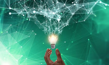 Business hand holding glowing light bulb against. 3d rendering