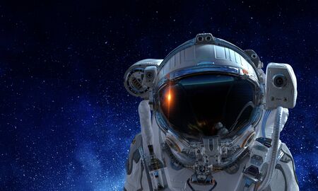 Astronaut man on space mission with starry sky on the background. Mixed mediaの写真素材
