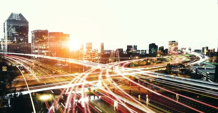 Modern night city silhoutte and blurred lightsの写真素材