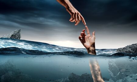 Man drowning in sea and asking for hand of help
