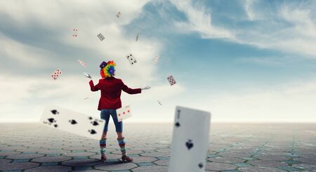 Woman with clown make up wearing wig juggling items . Mixed mediaの写真素材