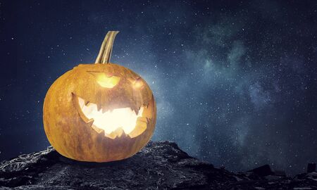 Big orange pumpkin on dark background. Mixed mediaの写真素材