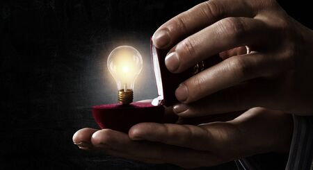 Light bulb inside gift box. Mixed media