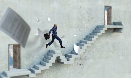 Side view of a black businessman climbing stone stairs illustrating career development and success...