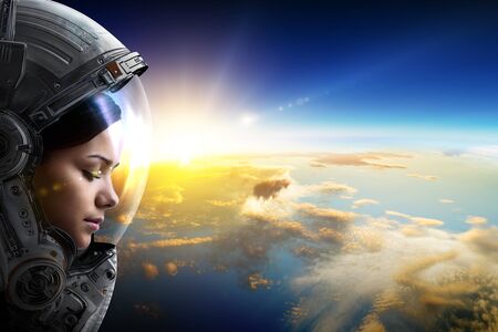 Female astronaut in space on planet orbit. . Mixed mediaの写真素材