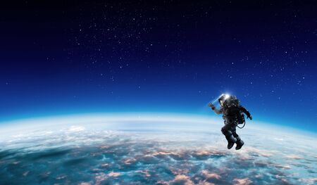 Astronaut at spacewalk on planet orbit.の写真素材