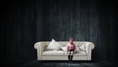 Dreamy little girl sitting alone ready for adventure. Mixed mediaの写真素材