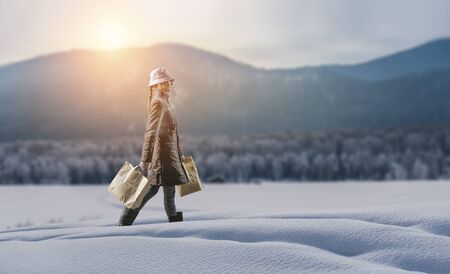 Housewife walking with shopping bagsの写真素材