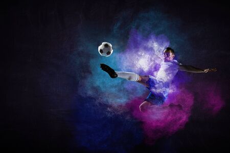 Boy playing soccer hitting the ball
