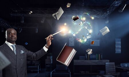 Conceptual image of ambitious and creative businessman in black suit holding paintbrush in hand