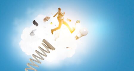 Businessman jumping on springboard . Mixed mediaの写真素材