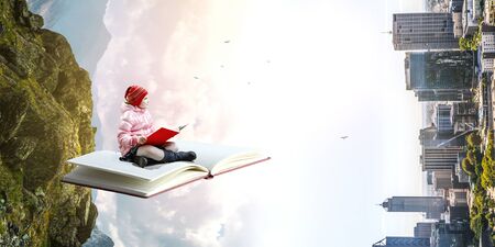 Little girl reading a bookの写真素材