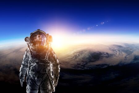Astronaut in space on planet orbit.の写真素材