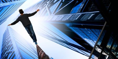 Man wearing virtual reality goggles and balancing on rope. Mixed media