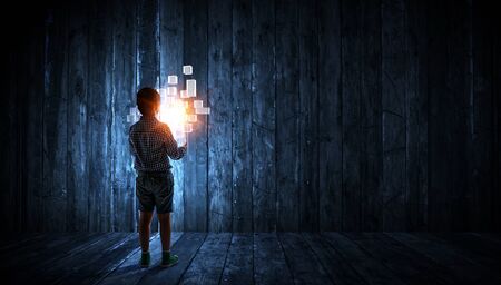 Boy alone at night with glowing cubesの写真素材
