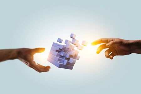 Hand holding glowing cubes. Innovation and creativity concept. Mixed mediaの写真素材