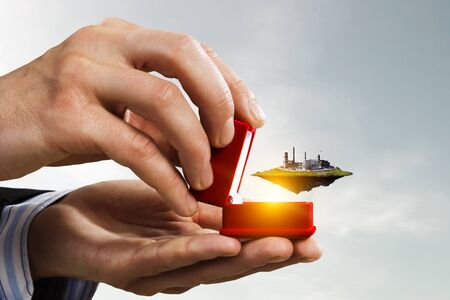 Floating industrial landscape inside gift box. Mixed mediaの写真素材