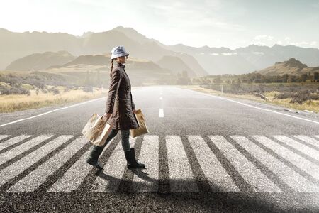 Housewife walking with shopping bagsの写真素材