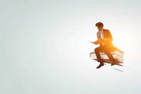 Man flying on a bookの写真素材