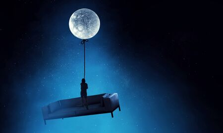 Kid boy catching moon . Mixed mediaの写真素材