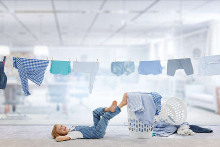 Happy little girl with washed clothesの写真素材