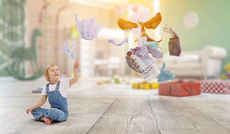 Happy little girl with washed clothesの写真素材