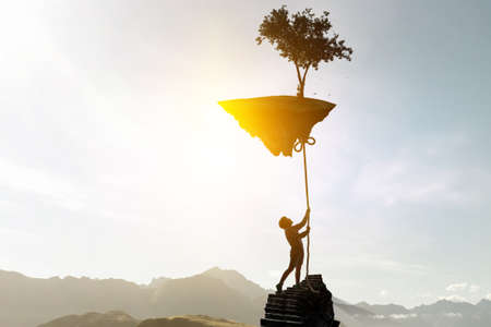 Kid holding island with a tree with ropeの写真素材