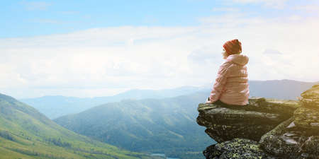 Dreamy little girl sitting aloneの写真素材
