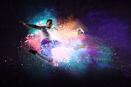 Boy playing soccer hitting the ballの写真素材